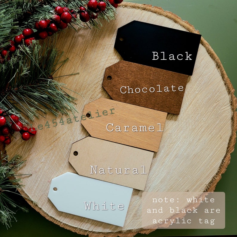 May include: Five different color gift tags, including black, chocolate, caramel, natural, and white. The white and black tags are acrylic, while the other tags are wood. The text "note: white and black are acrylic tag" is written below the tags.