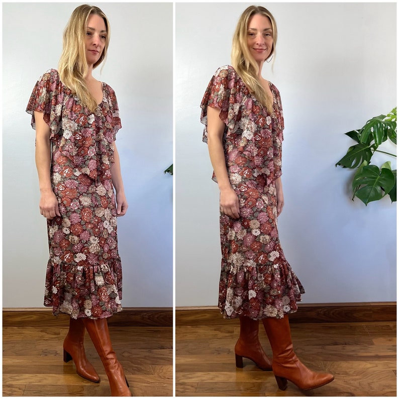 May include: A long floral print dress with a ruffled hem and short sleeves. The dress has a V-neckline and is made of a lightweight fabric. The model is wearing brown boots.