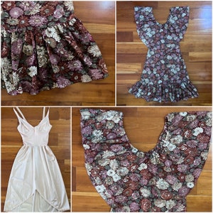 May include: Four floral print dresses in various styles and colors. The dresses are laid out on a wooden surface.