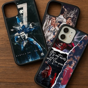 Op de afbeelding: Drie zwarte telefoonhoesjes met afbeeldingen van een voetballer. Eén hoesje toont de speler in een blauw tenue, een ander met een trofee en de derde met de tekst "It's not over until I'm win."