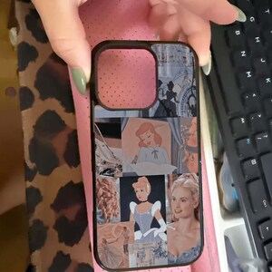 May include: Black phone case featuring a collage of images from the Disney movie Cinderella. The images include illustrations and photographs of Cinderella in various scenes. The case has a black border and a cutout for the camera.