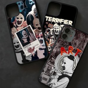 May include: Three black phone cases with horror-themed designs. One case features a collage of clown faces and a movie poster. Another displays the word "TERRIFIER" with a clown illustration. The third case has the word "ART" and a clown.