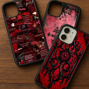 May include: Three black phone cases with unique designs. One case features a collage of red and white text and images. Another has a red floral pattern. The third case has a red background with black ornate detailing.