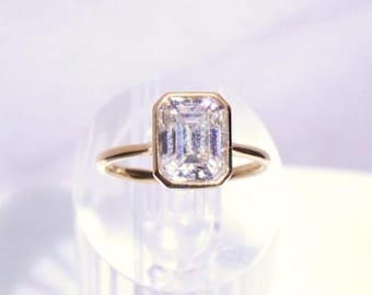 14k Gold Emerald Cut Moissanite Casey Ring: Lightweight Bezel Setting