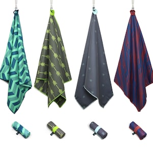 May include: Four different patterned microfiber towels hanging from hooks. The towels are rolled up and have a variety of colours and patterns, including green, blue, and red.