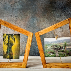 May include: Two wooden picture frames with a rustic finish, each holding a photograph. The frame on the left has a photo of a tree with a yellow and green color scheme. The frame on the right has a photo of a tree in a landscape setting.