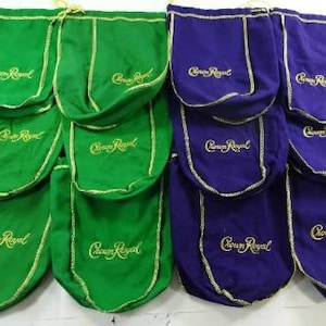 May include: A set of ten Crown Royal liquor bags, five green and five purple, with gold embroidery. The bags are made of a soft, fabric material and have a drawstring closure.