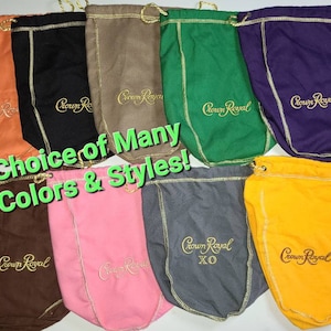 May include: A selection of drawstring bags in various colours, all displaying the Crown Royal logo embroidered in gold. The bags are crafted from a soft, textured fabric and feature a drawstring closure. The text "Choice of Many Colors & Styles!" is superimposed on the image.