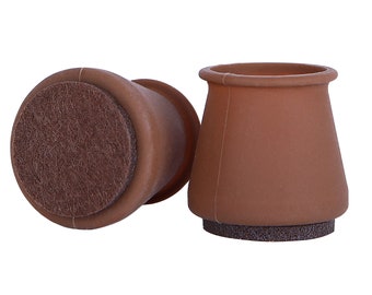 May include: Two brown furniture leg protectors with a felt bottom. The protectors are designed to prevent scratches on floors.