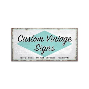 May include: A vintage-style sign with a turquoise diamond shape and the text "Custom Vintage Signs". The sign is made of metal and has a distressed white background. The text "12 by 24 inches, Any Text, Any Color, Free Shipping" is printed below the diamond.
