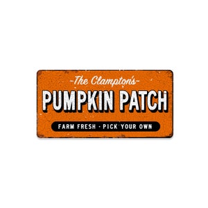 May include: Orange metal sign with distressed paint and white text that reads "The Clampton's Pumpkin Patch Farm Fresh - Pick Your Own"