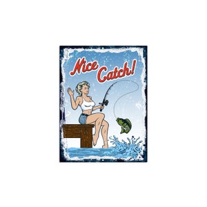 May include: A vintage-style illustration of a woman fishing on a dock. She is holding a fishing rod and has caught a fish. The text "Nice Catch!" is written in red letters on a blue background.