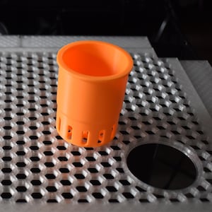 May include: A set of three ceramic mugs with a speckled, matte finish. The mugs are in shades of cream, light gray, and dark gray. Each mug has a simple, minimalist design, perfect for coffee or tea.