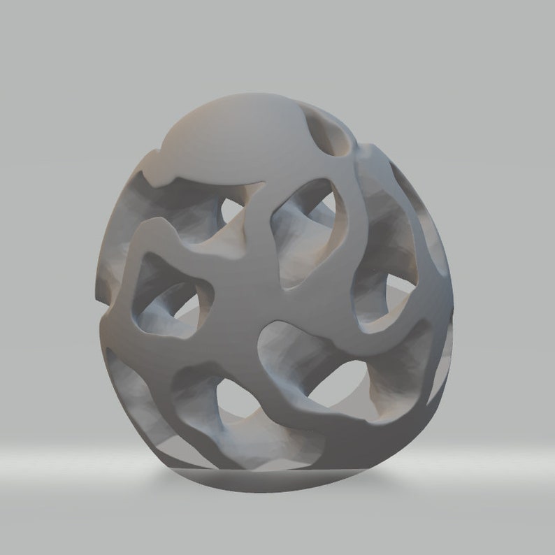 Puede incluir: Una escultura abstracta tridimensional de color gris con un dise&ntilde;o de rejilla. La escultura est&aacute; hecha de un material liso y s&oacute;lido y tiene una forma esf&eacute;rica.