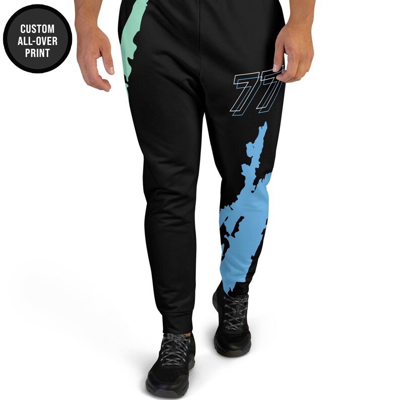 May include: Black sweatpants with a blue and green map print and the number "77" in white on the right leg.