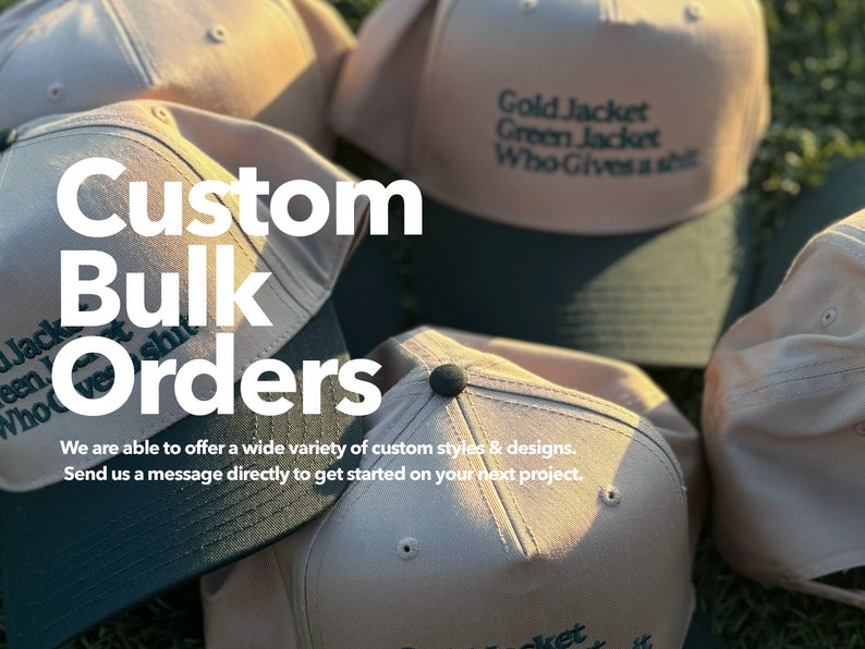 May include: A close-up of several beige baseball caps with green brims. The caps have different embroidered text, including "Gold Jacket", "Green Jacket", and "Who Gives a Shit". The text "Custom Bulk Orders" is superimposed on the image.
