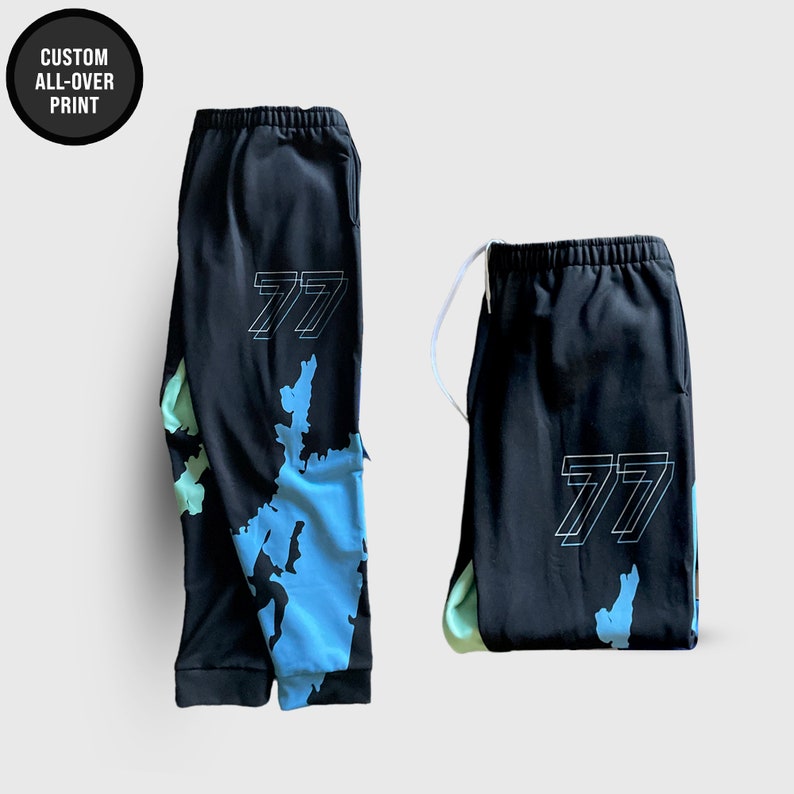 May include: Black sweatpants with a blue and green all-over print and the number "77" in white on the front and back.