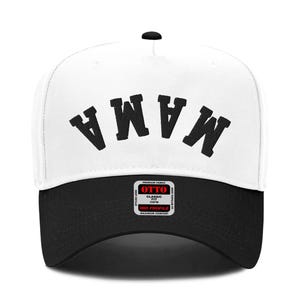 May include: White baseball cap with a black brim. The front of the cap has the word "MAMA" embroidered in black.