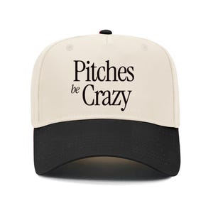May include: A beige and black baseball cap with the text "Pitches be Crazy" in black.