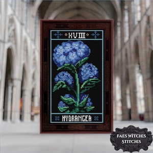 May include: Cross-stitch art of blue hydrangeas on a black background, framed in a dark brown wooden frame. The text "XVIII" and "HYDRANGEA" are included in the design. The artwork is from "FAES WITCHES STITCHES".