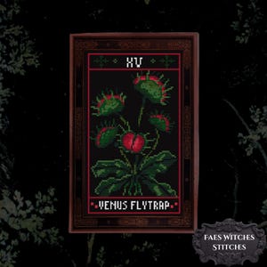 May include: A rectangular cross-stitch pattern featuring a Venus flytrap plant with green leaves and red-rimmed traps. The design is enclosed in a dark brown frame with the Roman numeral XV at the top and the text VENUS FLYTRAP at the bottom.