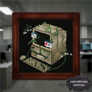 May include: Cross-stitch art of a vintage computer covered in vines and flowers, set against a black background. The computer has two open windows with flags. The artwork is framed in a dark brown wooden frame. The text "FAES WITCHES STITCHES" is at the bottom.