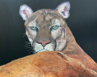 May include: A painting of a cougar with green eyes, looking directly at the viewer. The cougar is lying down with its head raised and its body partially obscured by the dark background.