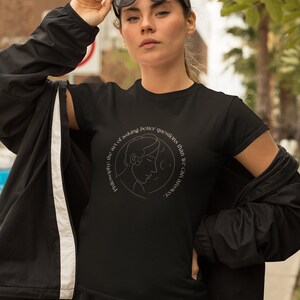 May include: Black t-shirt with a white line drawing of a person's head and the text "Philosophy: the art of asking better questions than we can answer."