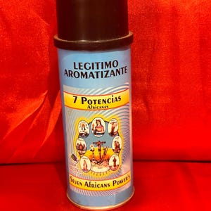 May include: A cylindrical, blue and black container with the text "LEGITIMO AROMATIZANTE" and "7 Potencias Africanas". The container features illustrations of religious figures and the words "Seven Africans Power's".