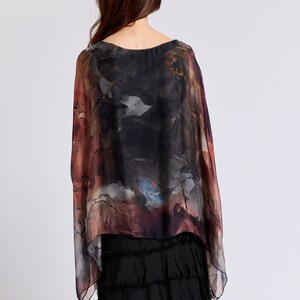 May include: A black and brown patterned silk top with a flowing, asymmetrical hem. The top has a loose, comfortable fit and is perfect for layering.