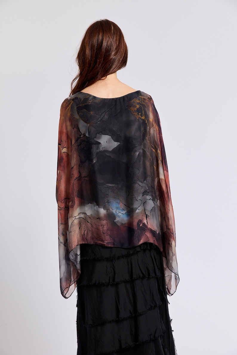 May include: A black and brown patterned silk top with a flowing, asymmetrical hem. The top has a loose, comfortable fit and is perfect for layering.