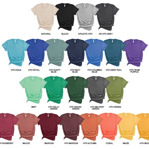May include: A variety of t-shirt colors displayed on a white background. The colors include natural, black, athletic heather, dark heather grey, aqua, royal blue, dusty blue, navy blue, columbia blue, deep teal, team purple, mint, kelly green, grass green, military green, green, raspberry, mauve, maroon, maroon, autumn, coral, maize, and mustard.