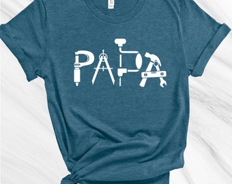 May include: A teal blue t-shirt with the word "PAPA" spelled out using images of tools.
