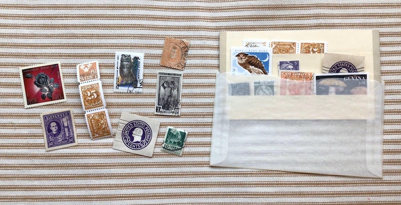 10 Postage stamps tucked in a vintage stock card and old glassine envelope. Seven of the stamps are actual postage stamps.