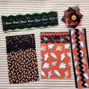 Samples of fabric flips and belly bands. You will receive one of each, plus a fabric cluster with a vintage button topper.