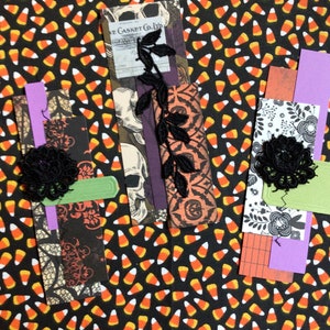 A Halloween themed paper cluster with black lace embellishments.