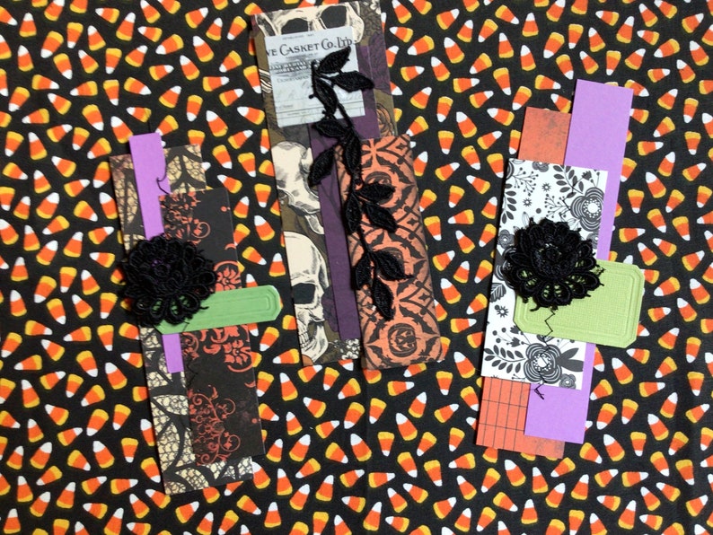 A Halloween themed paper cluster with black lace embellishments.