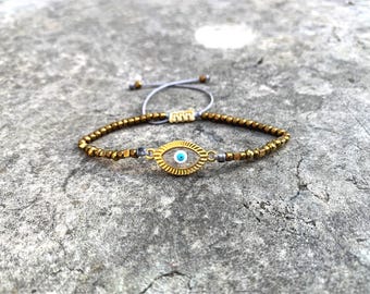 Pulsera de ojo turco con vidrieras: dije de protección con cuentas doradas, ajustable.