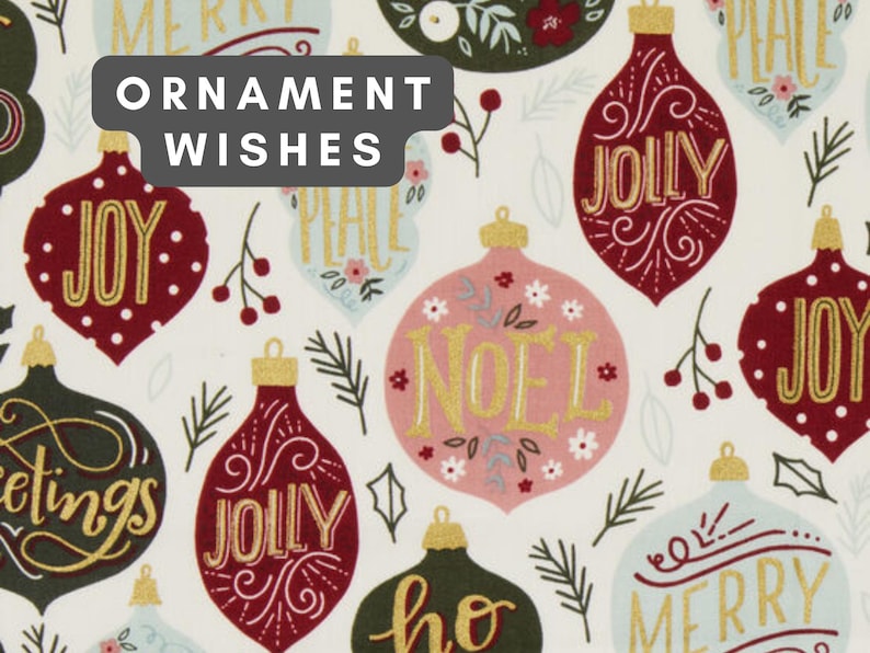 May include: A white fabric featuring a repeating pattern of Christmas ornaments in shades of red, dark green, and light blue. The ornaments are decorated with gold text including Joy, Jolly, Noel, and Merry, alongside small floral and pine sprig motifs.