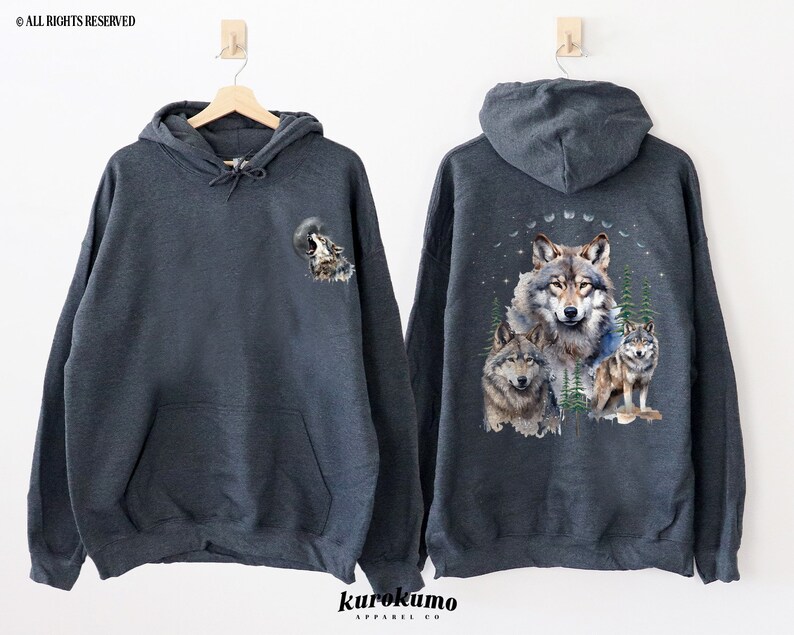 May include: A dark gray hooded sweatshirt with a wolf howling at the moon graphic on the front and a group of wolves in a forest scene on the back.