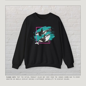 Puede incluir: Sudadera negra con un estampado gr&aacute;fico de dos orcas nadando en agua turquesa con un borde rosa y blanco. El texto "kurokumo APPAREL CO" est&aacute; en la parte inferior de la imagen.