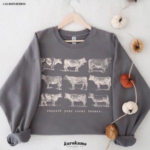 May include: Gray sweatshirt with a vintage illustration of cows and the text "support your local farmer."