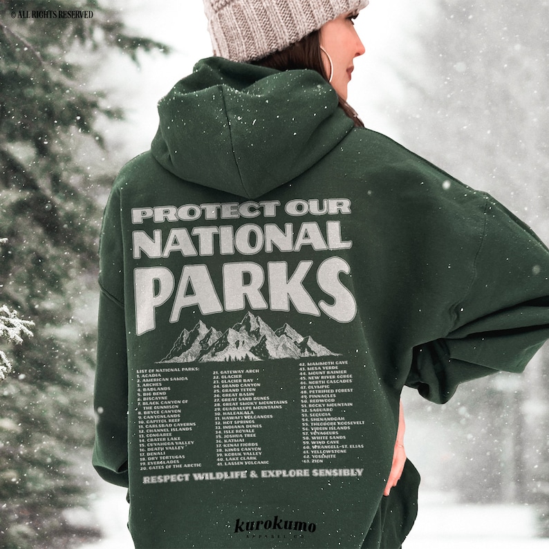 May include: A dark green hoodie with the text "PROTECT OUR NATIONAL PARKS" in white. Below the text is a mountain graphic. The back of the hoodie also lists national parks. The phrase "RESPECT WILDLIFE & EXPLORE SENSIBLY" is printed at the bottom.