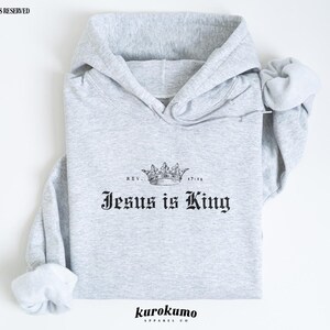 May include: Gray hooded sweatshirt with the text "Jesus is King" and a crown graphic. The text "Rev. 17:14" is printed above the crown.