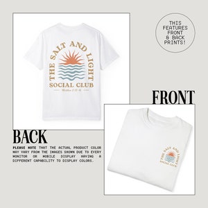 May include: White t-shirt with a graphic print of a sun setting over the ocean with the text "The Salt and Light Social Club" and "Matthew 5:13-16". The back of the shirt has a similar graphic with the text "The Salt and Light Social Club".