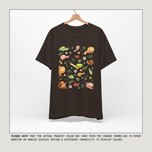 May include: A brown t-shirt with a graphic print of snails and leaves. The text "COLOR OPTIONS" is at the top of the image. The text "MESSAGE US IF INTERESTED IN ANOTHER COLOR NOT SHOWN" is at the top right of the image. The text "PLEASE NOTE THAT THE ACTUAL PRODUCT COLOR MAY VARY FROM THE IMAGES SHOWN DUE TO EVERY MONITOR OR MOBILE DISPLAY HAVING A DIFFERENT CAPABILITY TO DISPLAY COLORS." is at the bottom of the image. The text "COPYRIGHT" is at the bottom left of the image. The text "kurokumo APPAREL CO" is in the center of the image. The text "ALL RIGHTS RESERVED" is at the bottom right of the image.