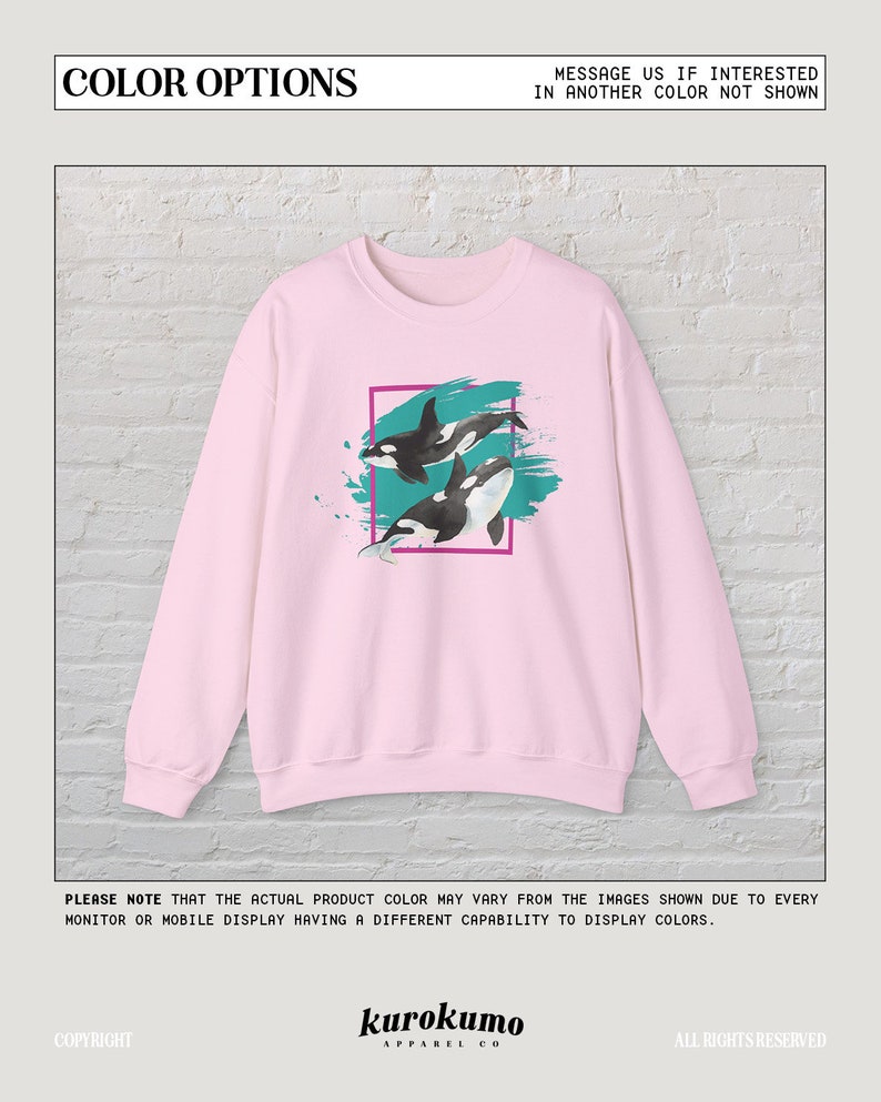 Puede incluir: Sudadera rosa con un estampado gr&aacute;fico de dos orcas nadando en agua turquesa con un efecto de pinceladas rosa y blanco. El gr&aacute;fico est&aacute; enmarcado en un cuadrado rosa.