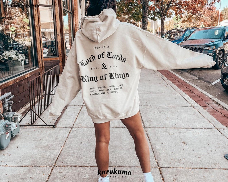 May include: A cream-colored hoodie with a black print on the back that reads "FOR HE IS Lord of Lords & King of Kings AND THOSE WHO ARE WITH HIM ARE CALLED, CHOIEK, AND FAITHFUL".