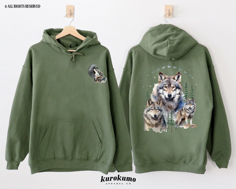 May include: A green hooded sweatshirt with a wolf howling at the moon graphic on the front and a group of wolves in a forest scene on the back.