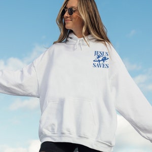 May include: White hooded sweatshirt with a blue graphic of a globe with the text "JESUS SAVES" on it.